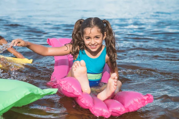 Little girl on inflatable mattresses — Stock Photo, Image