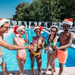 Multiethnic people at Christmas pool party
