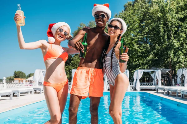 Multiethnic people at Christmas pool party — Free Stock Photo