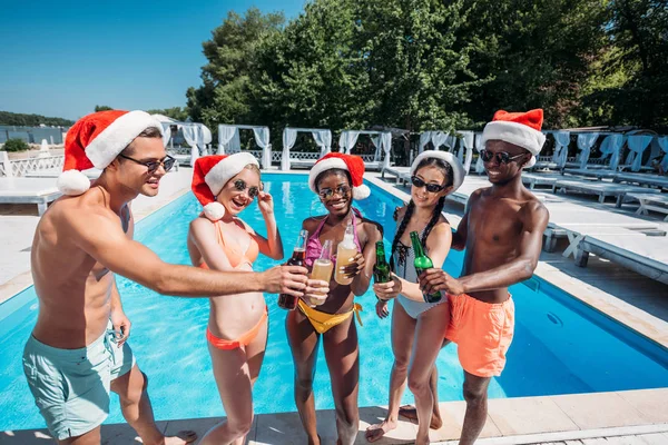 Multiethnic people at Christmas pool party — Free Stock Photo