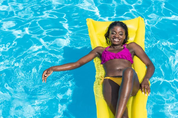Woman on inflatable mattress in pool — Stock Photo, Image
