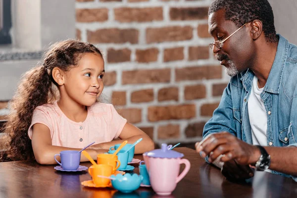 Girl having tea party with father — Stock Photo, Image