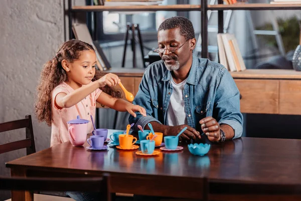 Girl having tea party with father — Stock Photo, Image