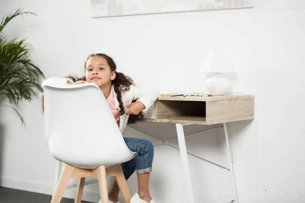 African american girl sitting on chair — Stock Photo, Image