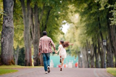 girl walking with grandfather in park  clipart