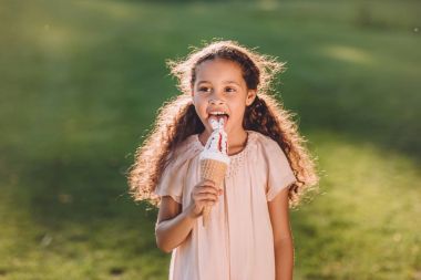 girl licking ice cream clipart