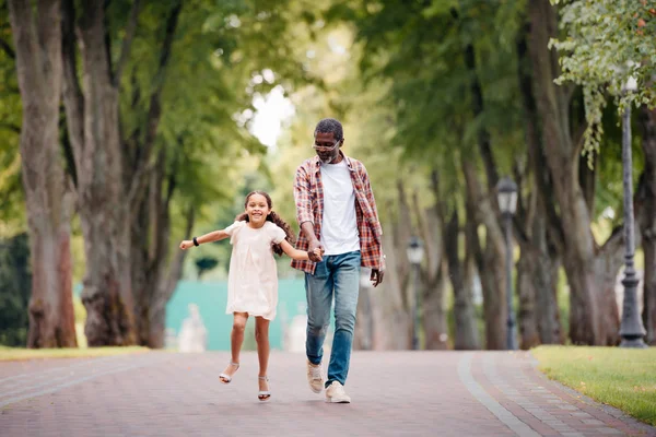 Girl holding hands with grandfather — Stock Photo, Image