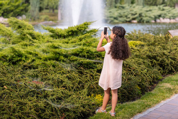 girl taking photo on smartphone