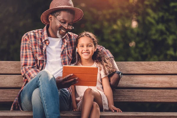 Granddaughter and grandfather listening music — Stock Photo, Image