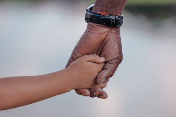 grandfather holding hands with granddaughter  