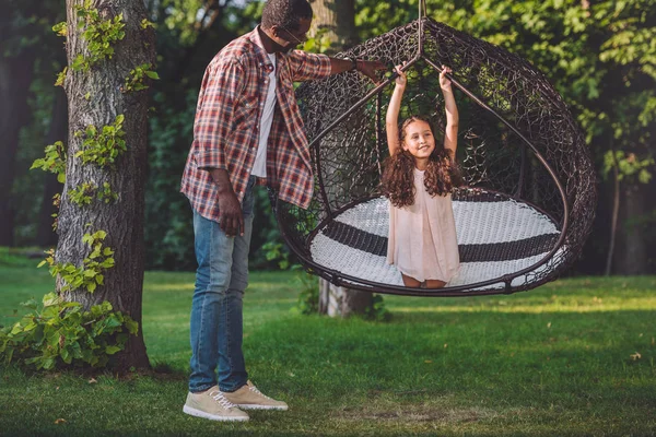 Girl on swinging hanging chair — Stock Photo, Image