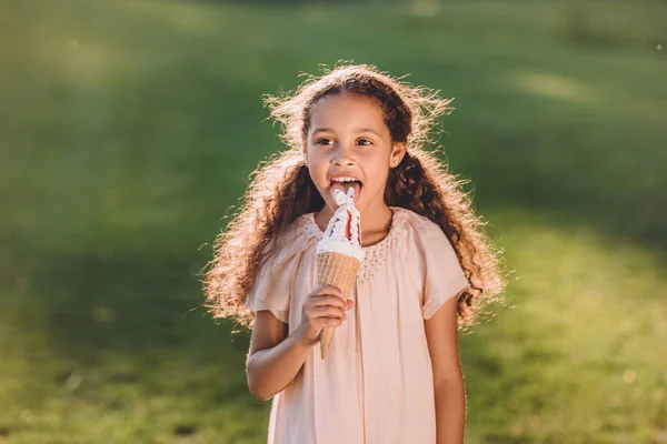 Girl licking ice cream — Stock Photo, Image