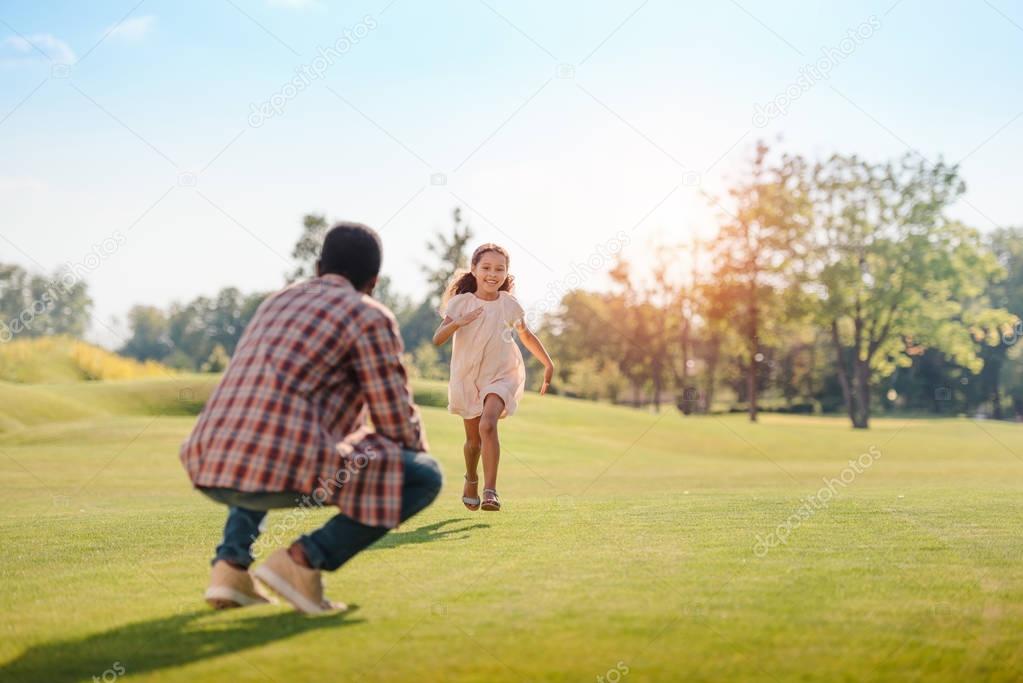 granddaughter running to grandfather
