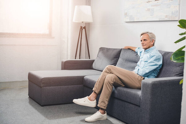 senior man sitting on sofa