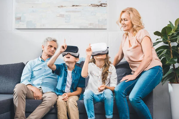 Grandchildren using virtual reality headsets — Stock Photo, Image