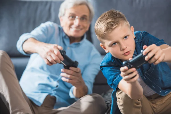 Grandfather and grandson with joysticks — Stock Photo, Image