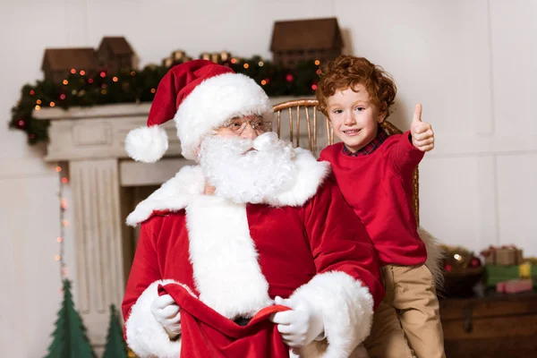 Santa claus and little boy — Free Stock Photo