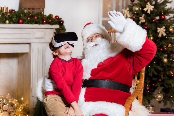 santa claus and kid in vr headset