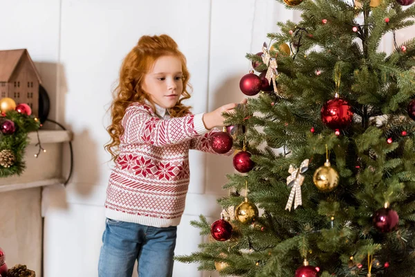 Kind schmückt Weihnachtsbaum — Stockfoto