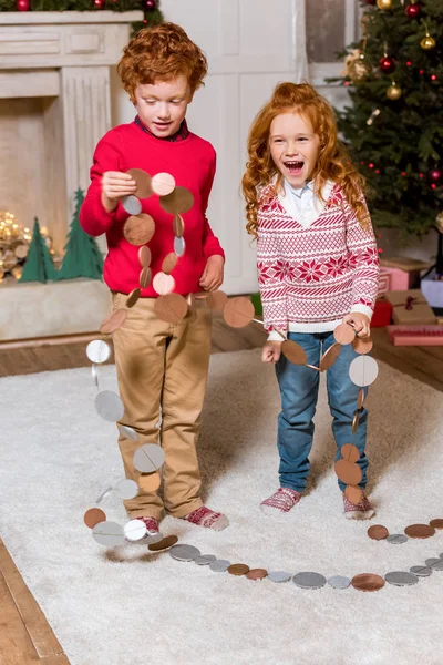 Glückliche Kinder mit festlichem Kranz — Stockfoto