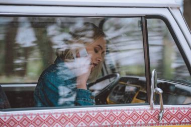 girl using smartphone in minivan clipart