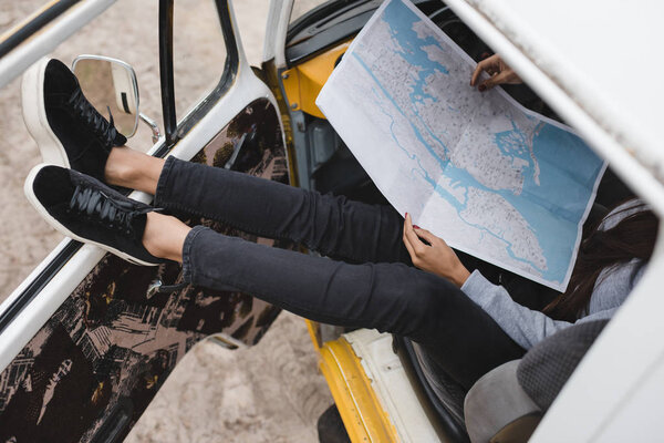 traveler with map in minivan
