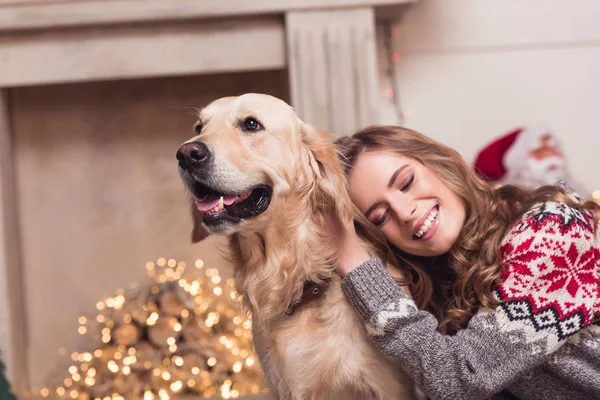 Ung kvinna och hund på christmastime — Stockfoto