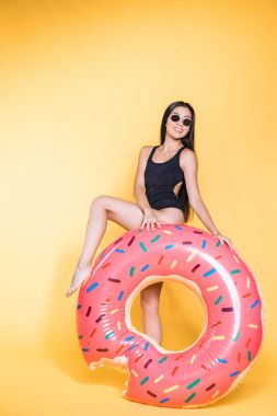 woman in swimsuit with doughnut pool float clipart