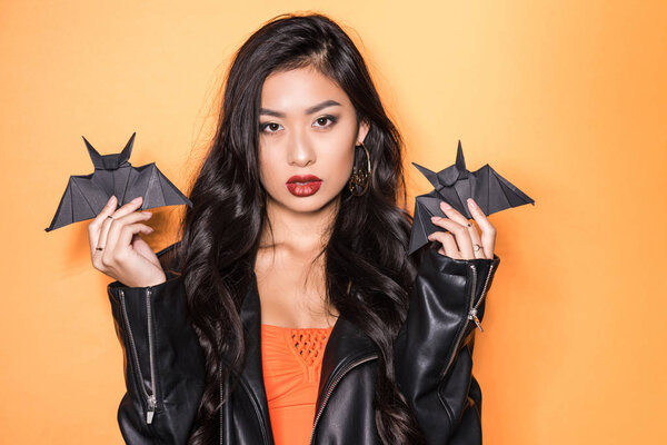 woman holding origami bats