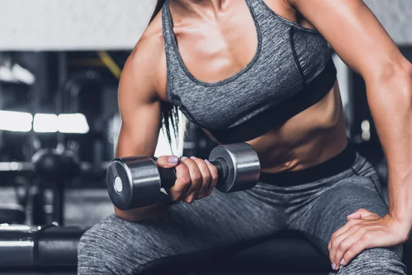 Sportive woman exercising with dumbbell — Stock Photo, Image