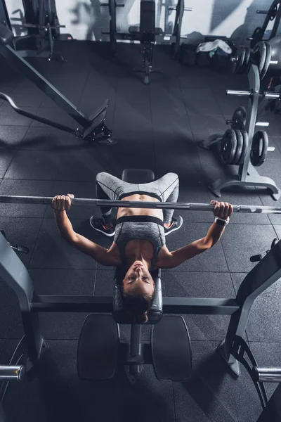 Mulher levantando barbell — Fotografia de Stock