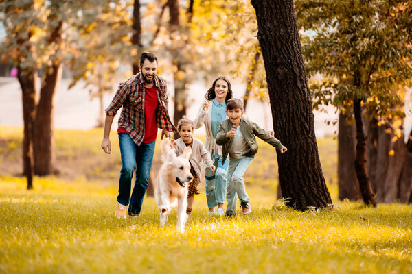 family running after dog