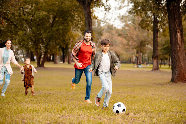 Family playing soccer