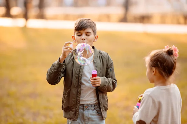 Boy blowing soap bubbles — Stock Photo, Image