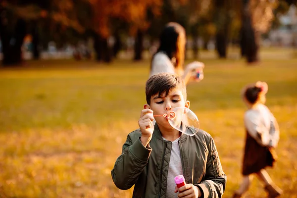 Boy blowing soap bubbles — Stock Photo, Image