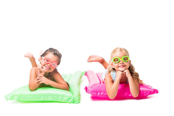 happy kids on swimming mattresses