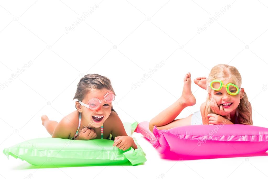 happy kids on swimming mattresses