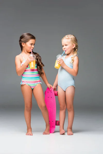 Kids with skateboard and juice — Stock Photo, Image