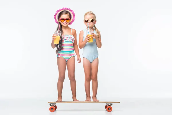 Kids with skateboard and juice — Stock Photo, Image