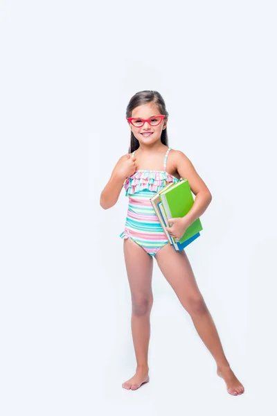 Kid met boeken en partij stok — Stockfoto