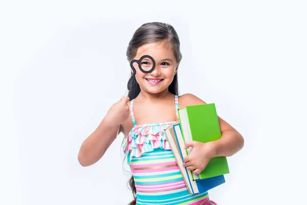 Kid with books and party stick — Stock Photo, Image