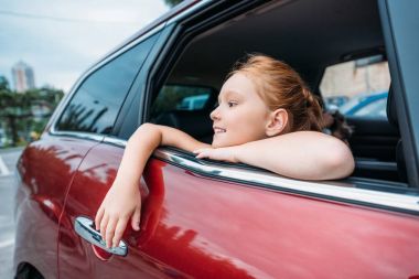 girl looking out car window clipart