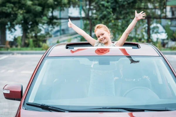 Girl peering out of sun roof — Stock Photo, Image