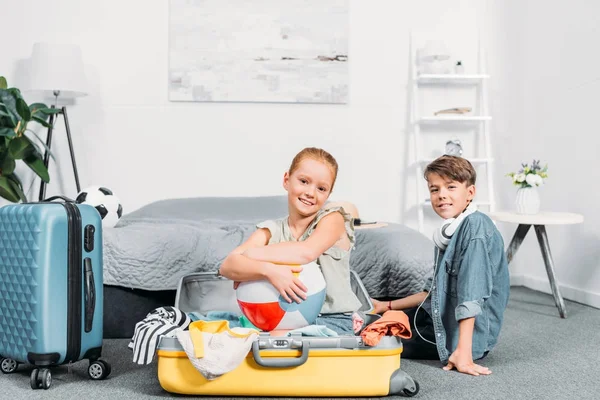 Kids packing clothes for trip — Stock Photo, Image