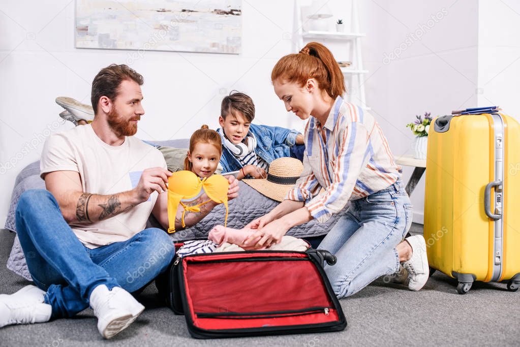 family packing luggage for trip