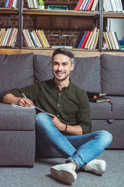 Handsome student in library — Stock Photo, Image