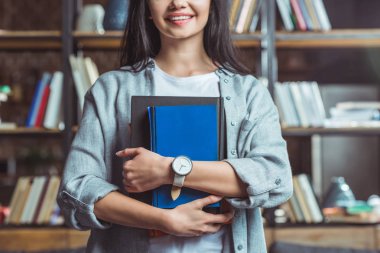 girl holding books