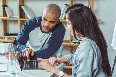 multiethnic couple using laptop clipart