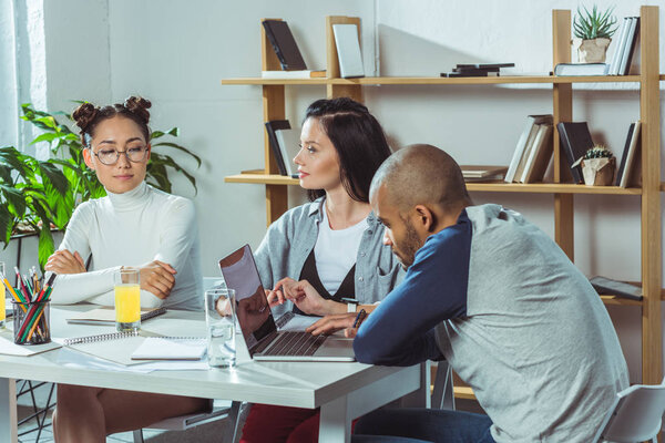 multiethnic students with notebooks and laptop