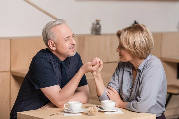 Lovely couple holding by hands — Stock Photo, Image